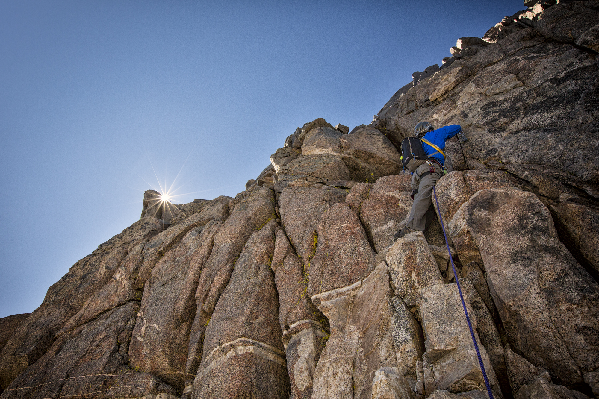 Climbing the final pitch to the summit of Thunderbolt Peak, Kings Canyon National Park. I was belaying my friend and only took my hands off the rope when he was in a secure position, just as the sun peaked above the rock. No climbers were hurt in getting the shot.