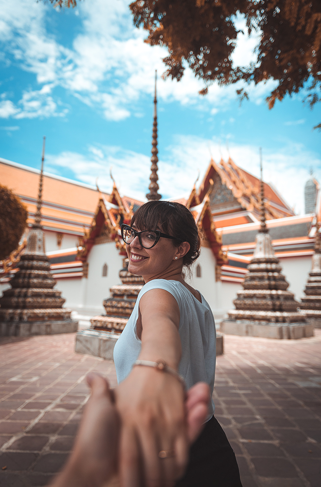 girl smiling and holding photographer's hand